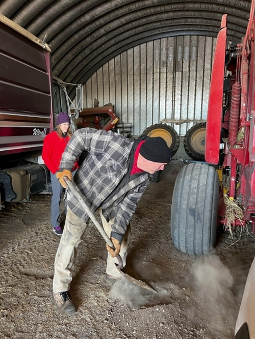 Farmer shoveling. Dr. Lang and team recording. Photo by Merle Massie. 2023