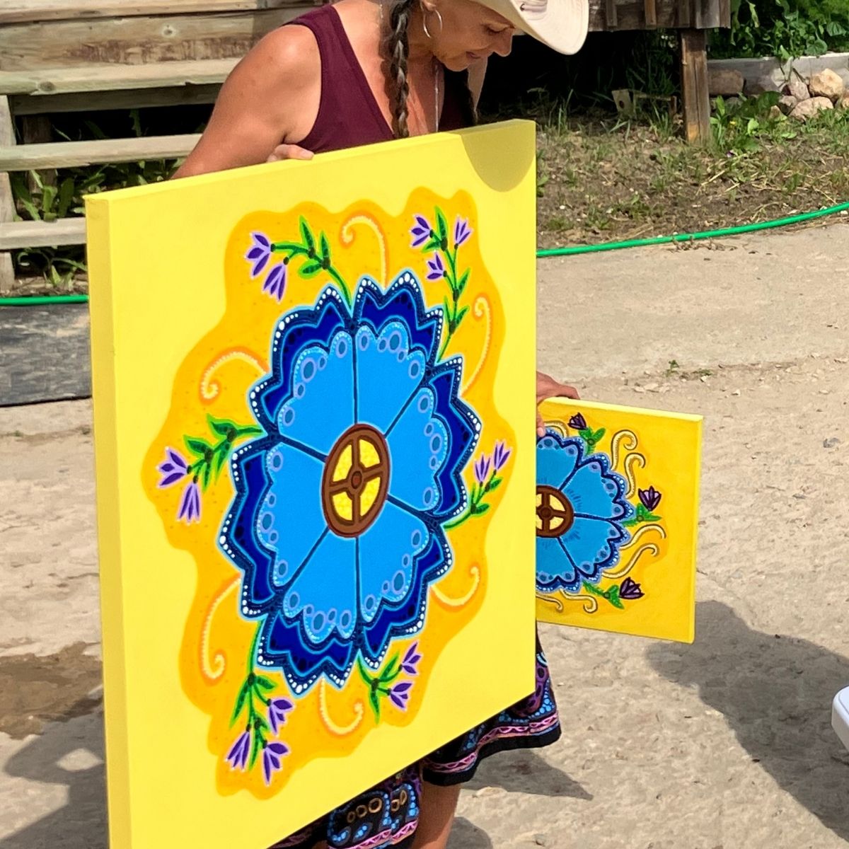 Métis artist Leah Marie Dorion with her Northern Flower painting.